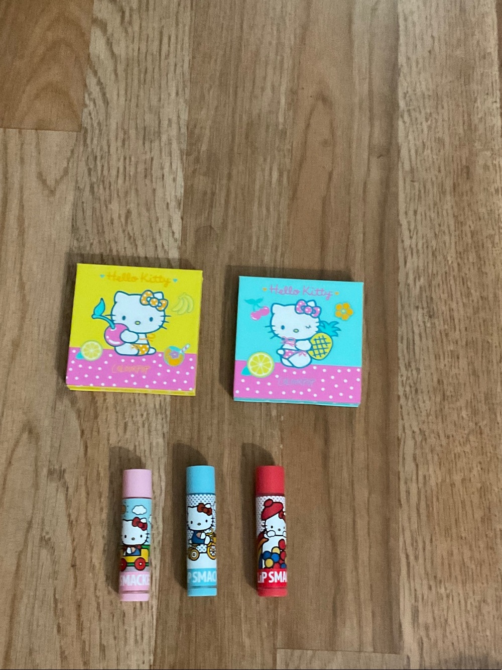 Hello Kitty Lip Balm Trio with Pink, Blue & Red Tubes and Yellow & Blue Boxes